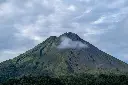 shot-breathtaking-giant-mountain-covered-forests-gleaming-cloudy-sky.webp